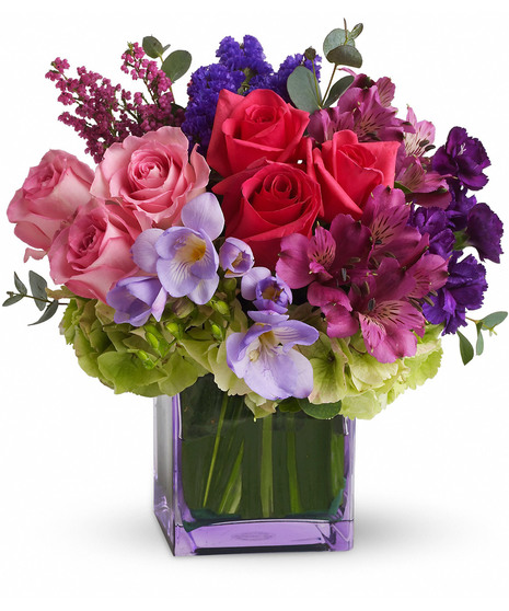 Lavender cube vase filled with purple, pink and lavender flowers