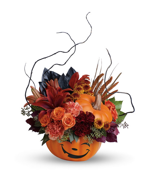 Halloween bouquet of lilies, carnations, mums and fall accents in a ceramic pumpkin vase
