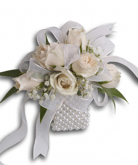 Wristlet created with white roses and baby's breath on a faux pearl cuff
