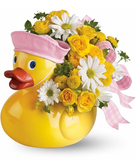 Charming duck container filled with yellow and white flowers and topped with a pink bow